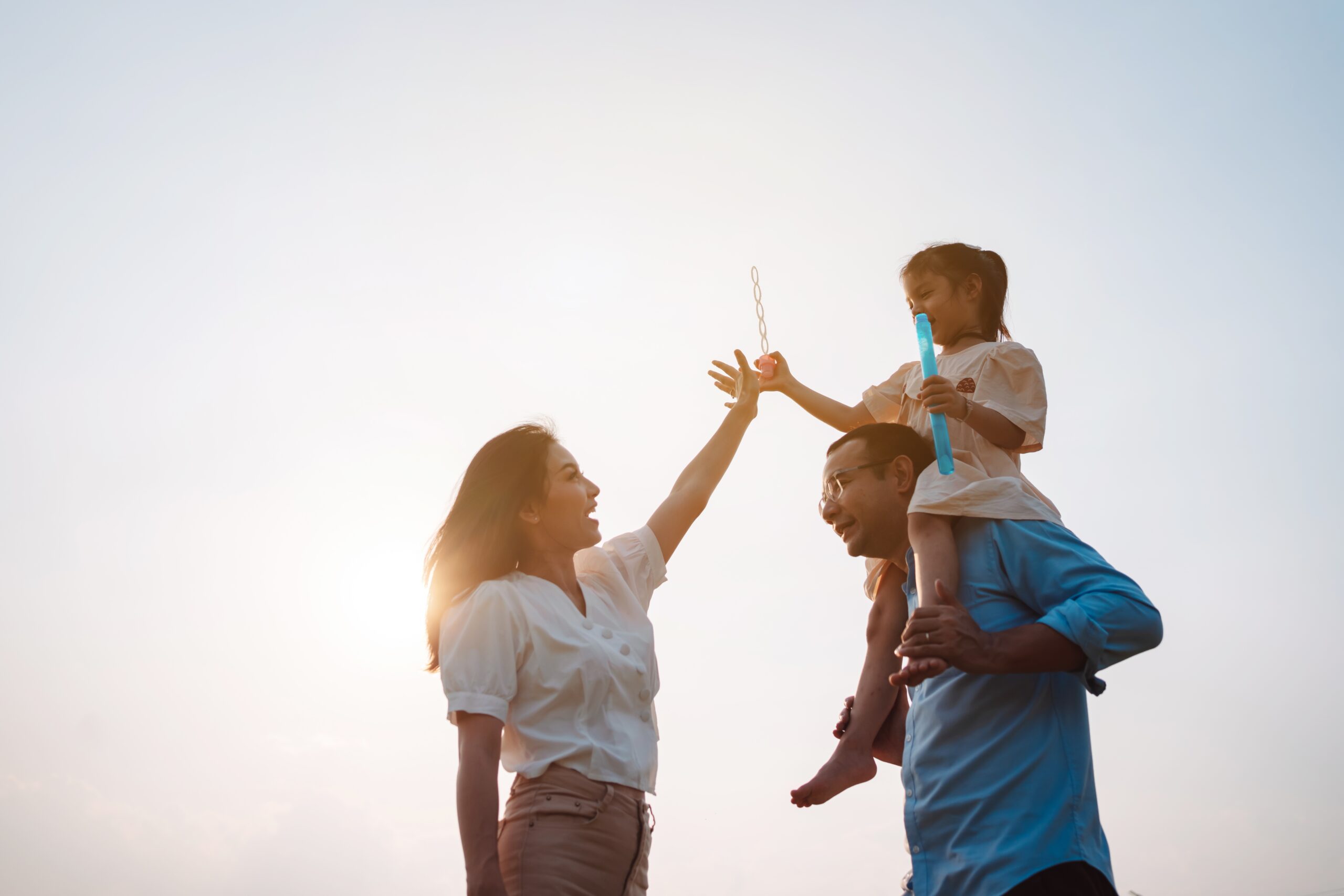 happy family in the park at sunset